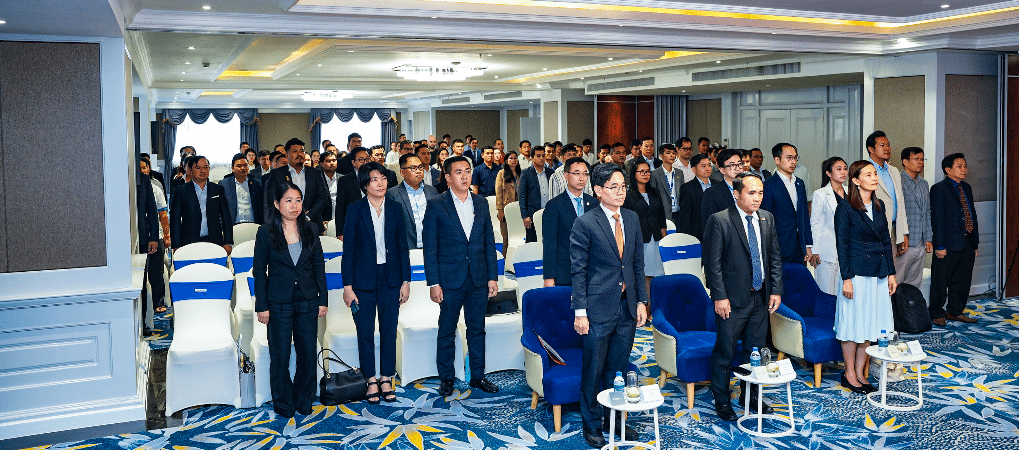 Attendees and speakers stand in respect during the opening of the 3rd Young Entrepreneurs Gathering 2025, an event by YEAC and CCC in Phnom Penh for Cambodian entrepreneurs.