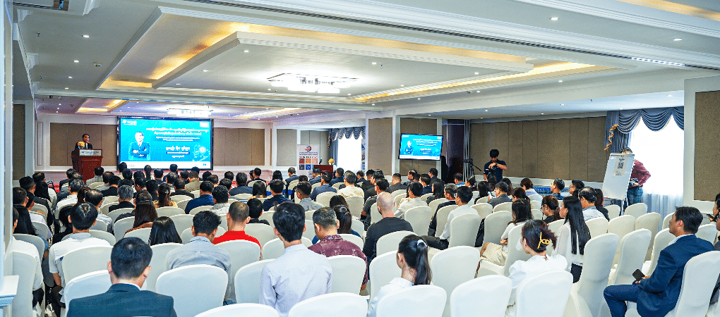A keynote speaker addresses a large audience of entrepreneurs at the 3rd Young Entrepreneurs Gathering 2025 in Phnom Penh, an event by YEAC and CCC focused on digital skills and AI.